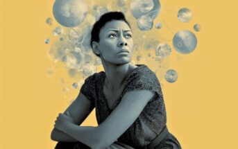 A woman with a thoughtful expression sits with arms crossed, looking upward. Abstract floating spheres surround her head, suggesting contemplation. The background is solid yellow.