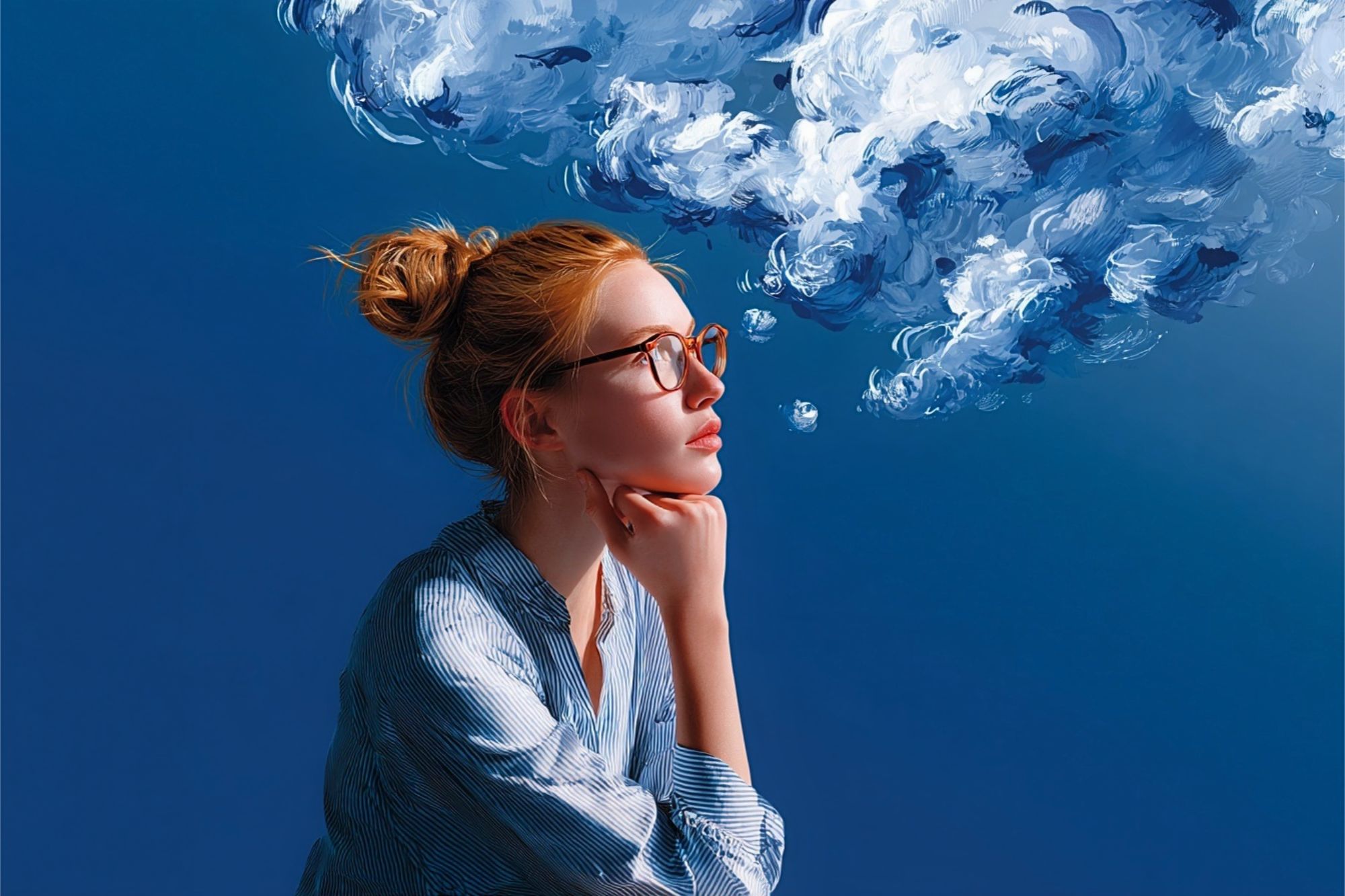 A person with glasses and a bun rests their chin on their hand as a large, painted-style cloud emerges from their mouth.
