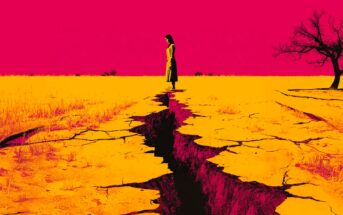 A woman stands at the edge of a deep crack in dry, yellow earth under a vivid pink sky, with a barren tree to the right and sparse vegetation in the background.