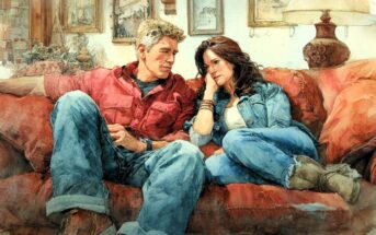 A man and woman sit close together on a red couch, casually dressed in denim and relaxed poses, looking at each other in a cozy, warmly lit living room with framed pictures and a lamp in the background.