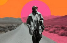 A smiling woman wearing sunglasses and a coat walks down a deserted rural road. The background features grayscale mountains and vibrant, abstract orange and pink sun shapes.