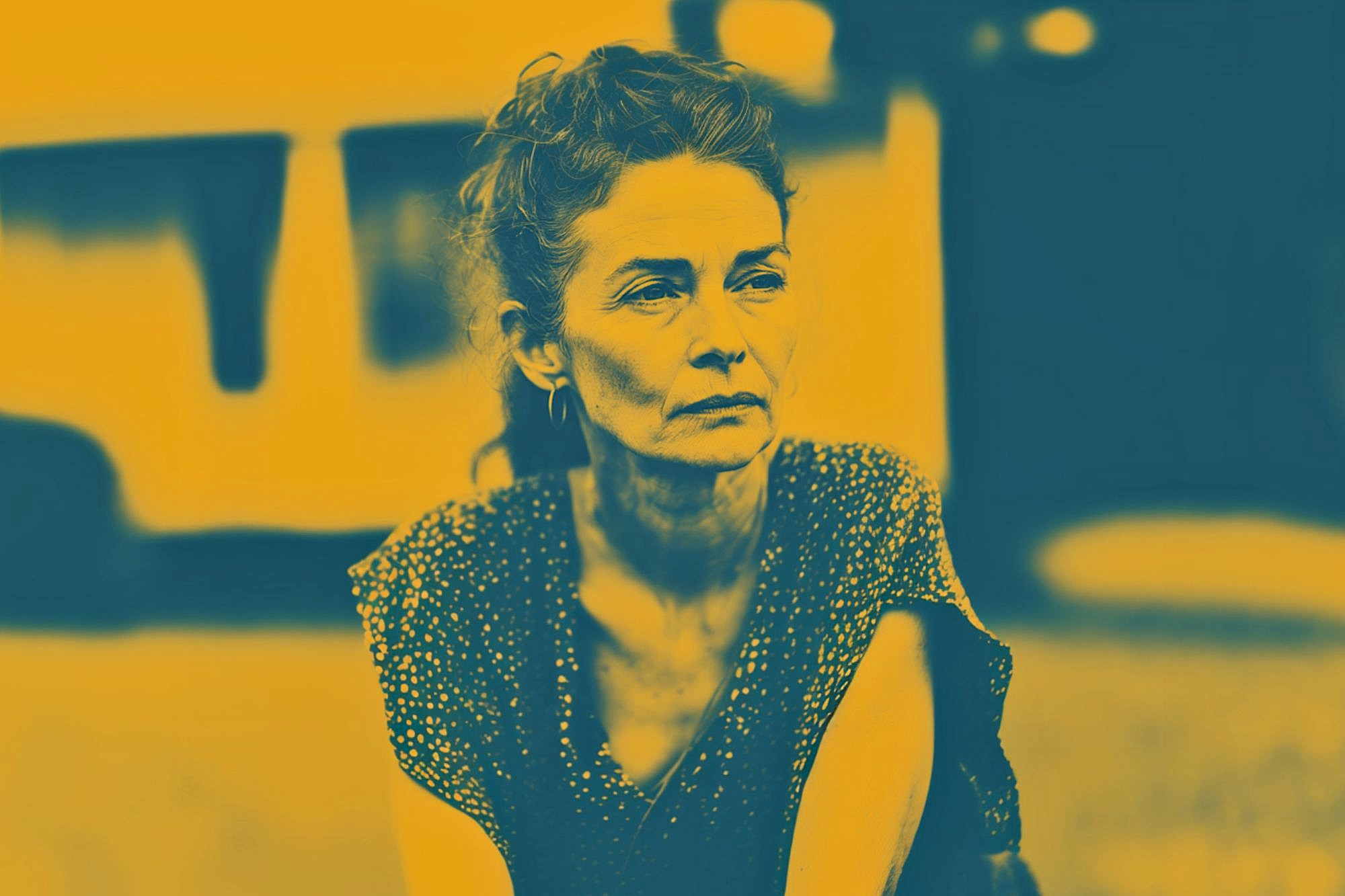 A woman with curly hair and hoop earrings looks pensively to the side. The image uses a strong yellow and dark blue color filter, giving it a dramatic and artistic effect. The background is blurred.