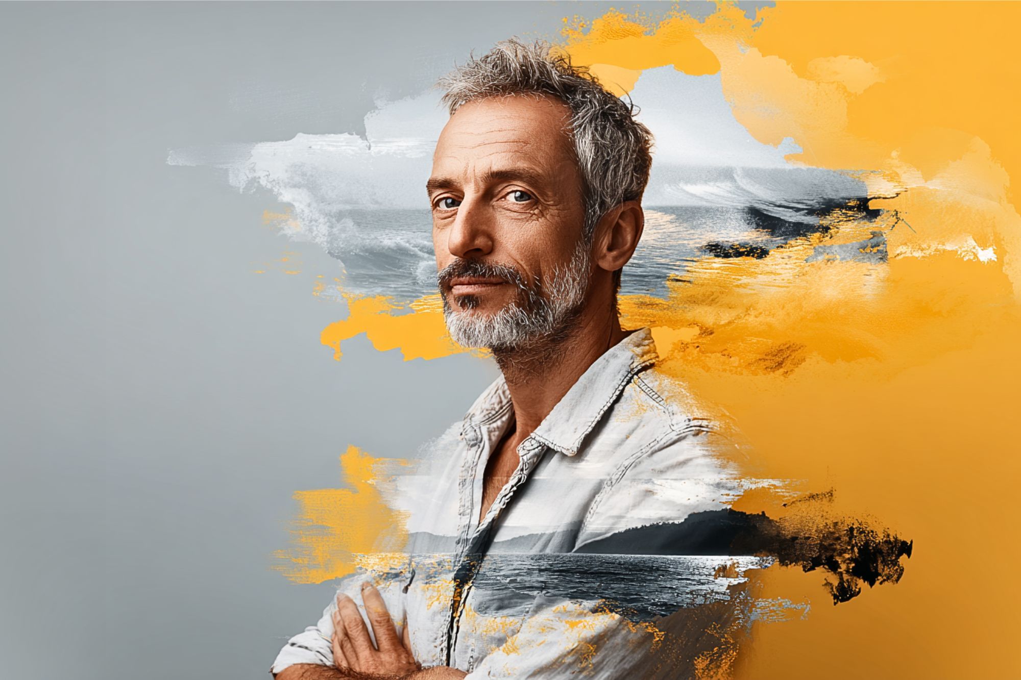 A middle-aged man with gray hair and beard stands with folded arms, wearing a light denim shirt. Artistic brushstrokes in yellow, black and white blend the background and foreground, creating a dynamic, creative effect.
