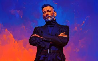 A confident man with a gray beard and mustache stands with arms crossed, wearing a dark suit and turtleneck, against a vibrant, abstract background of blue and orange hues.