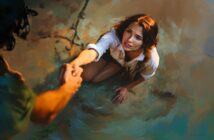 A woman kneels on the ground, reaching up as another person extends a hand to help her. She looks up with a hopeful expression, grasping the offered hand. The scene is bathed in warm, dramatic lighting.