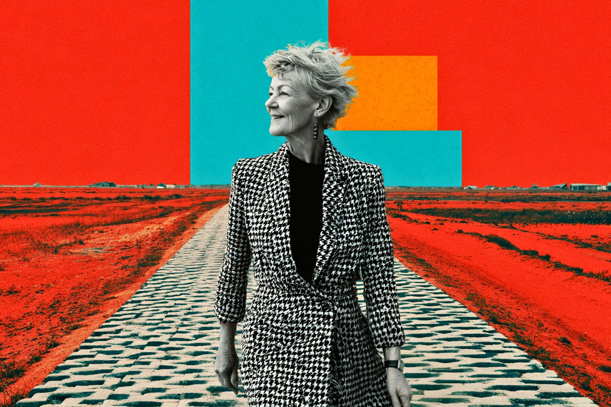 An older woman in a black-and-white houndstooth coat stands on a patterned path in a surreal, vividly colored landscape with bold red ground and geometric shapes in blue and yellow against a red sky.