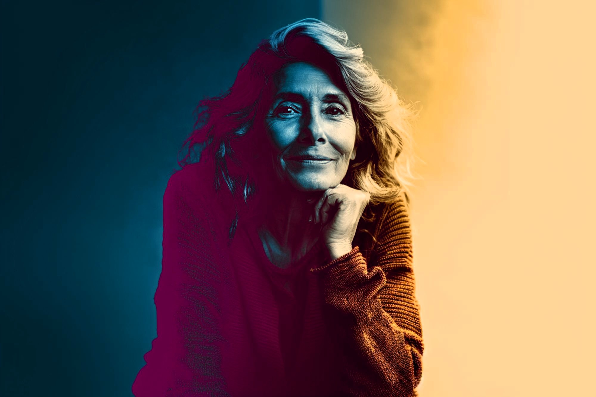 A woman with wavy hair and a warm sweater rests her chin on her hand, smiling softly. The image uses dramatic lighting with blue tones on one side and warm yellow on the other, creating a vivid color contrast.