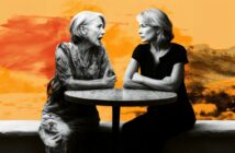 Two women sit across from each other at a round table, one animatedly talking while the other listens with arms crossed. The background is a vibrant mix of orange and yellow tones.
