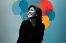 A smiling woman sits against a blue background with overlapping, translucent circles in blue, red, and yellow behind her head, creating an artistic and vibrant effect.