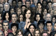 A large, diverse group of people stands close together, all holding a finger to their lips in a gesture indicating silence or secrecy. The mood is serious and focused, with everyone facing forward.