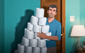 A man stands in a doorway holding a large, uneven stack of toilet paper rolls. The room has teal walls, a lamp, and a wooden door.