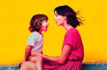 A woman in a pink dress sits facing a young child in a white shirt. Both have open mouths as if talking or singing. The background is bright yellow, creating a cheerful and vibrant scene.