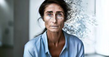 A woman in a blue shirt stares ahead as the right side of her face and hair dissolve into abstract particles, blending with a blurred indoor background.