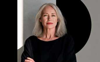 Portrait of a woman with long gray hair wearing a black top.