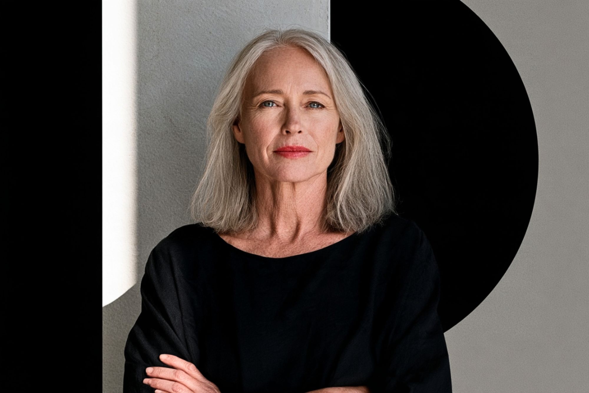 Portrait of a woman with long gray hair wearing a black top.