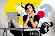 A woman sits at a desk with a desktop computer, resting her chin on her hands, appearing thoughtful. The background is abstract with bold yellow, red, and black shapes and doodles.