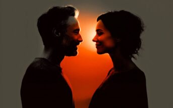 A man and a woman face each other, smiling, with warm orange light glowing between them, creating strong silhouettes against a dark background.
