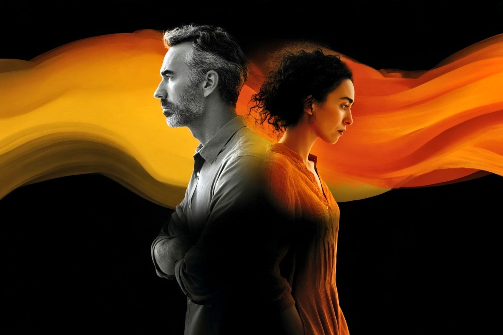 A man and a woman stand back to back, both looking serious. An orange-yellow swirling streak flows between and behind them against a black background.