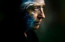An elderly person’s face in profile, partly blended with an image of Earth, symbolizing deep thought and environmental connection.