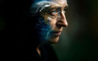 An elderly person’s face in profile, partly blended with an image of Earth, symbolizing deep thought and environmental connection.