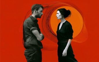 A man and woman face each other against a vivid red background with an orange circle and sketch-like swirl behind them, both dressed in dark clothing, appearing serious.