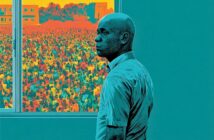 A man stands indoors near a window, looking out at a large, colorful crowd and orange-toned buildings under a vivid sky. The image uses bold, stylized colors and shading.