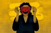 A person with dark hair and clothing holds a red smiling mask over their face against a yellow background with abstract shapes.