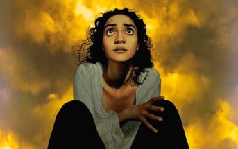 A woman with curly hair looks up with a worried expression, crouched with hands clasped, against a dramatic yellow and orange cloudy sky background.
