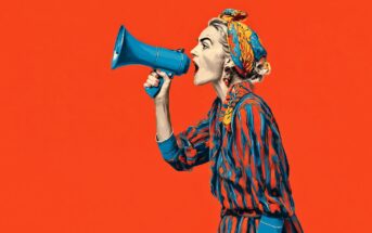 A woman in a striped dress and headscarf shouts into a blue megaphone against a bright orange background. The image has a bold, pop art style.