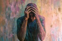 A painting of a man holding his head in his hands, appearing distressed, with a colorful, textured background.