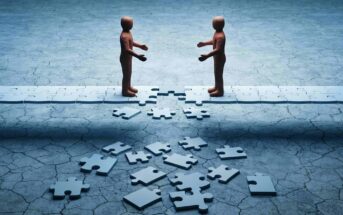 Two faceless figures stand on opposite sides of a broken bridge made of puzzle pieces.