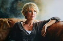 A realistic painting of a blonde woman resting on a leather sofa, looking toward her right.