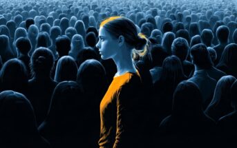 A young woman in a glowing orange shirt stands in profile amidst a vast, dimly lit crowd of people shown in silhouette.